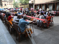 Devotees have offerings after worshiping the Hindu goddess Kali outside a ''pandal,'' a decorated temporary platform, on the occasion of the...