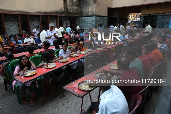 Devotees have offerings after worshiping the Hindu goddess Kali outside a ''pandal,'' a decorated temporary platform, on the occasion of the...