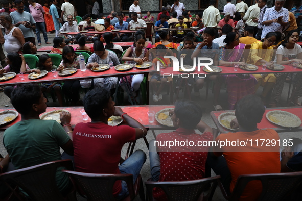 Devotees have offerings after worshiping the Hindu goddess Kali outside a ''pandal,'' a decorated temporary platform, on the occasion of the...