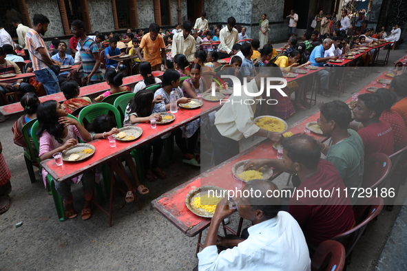 Devotees have offerings after worshiping the Hindu goddess Kali outside a ''pandal,'' a decorated temporary platform, on the occasion of the...