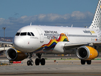 An Airbus A320-232 from Vueling, featuring the ''Born This Way, Fly This Way'' livery, is on the runway after landing at Barcelona El Prat A...