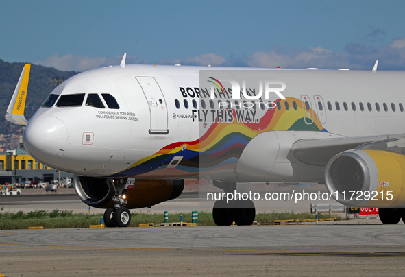 An Airbus A320-232 from Vueling, featuring the ''Born This Way, Fly This Way'' livery, is on the runway after landing at Barcelona El Prat A...