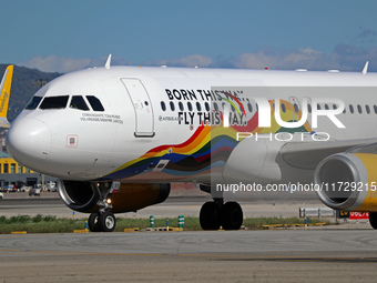 An Airbus A320-232 from Vueling, featuring the ''Born This Way, Fly This Way'' livery, is on the runway after landing at Barcelona El Prat A...