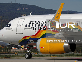 An Airbus A320-232 from Vueling, featuring the ''Born This Way, Fly This Way'' livery, is on the runway after landing at Barcelona El Prat A...