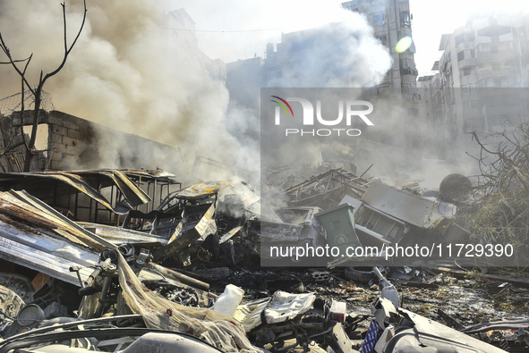 Firefighters extinguish the blaze at the site of overnight Israeli airstrikes that target the neighborhood of Kafaat in Beirut's southern su...