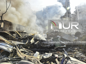 Firefighters extinguish the blaze at the site of overnight Israeli airstrikes that target the neighborhood of Kafaat in Beirut's southern su...