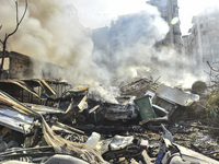 Firefighters extinguish the blaze at the site of overnight Israeli airstrikes that target the neighborhood of Kafaat in Beirut's southern su...