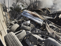 Firefighters extinguish the blaze at the site of overnight Israeli airstrikes that target the neighborhood of Kafaat in Beirut's southern su...