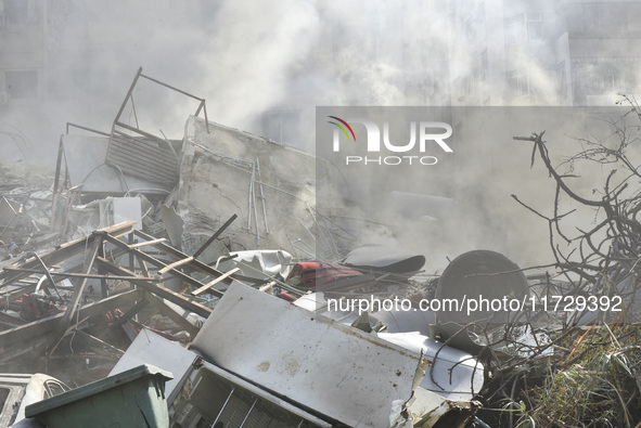 Firefighters extinguish the blaze at the site of overnight Israeli airstrikes that target the neighborhood of Kafaat in Beirut's southern su...