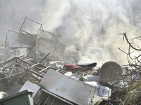 Firefighters extinguish the blaze at the site of overnight Israeli airstrikes that target the neighborhood of Kafaat in Beirut's southern su...