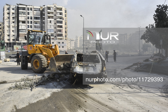 Firefighters extinguish the blaze at the site of overnight Israeli airstrikes that target the neighborhood of Kafaat in Beirut's southern su...