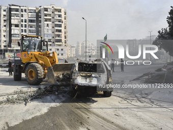 Firefighters extinguish the blaze at the site of overnight Israeli airstrikes that target the neighborhood of Kafaat in Beirut's southern su...