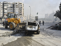 Firefighters extinguish the blaze at the site of overnight Israeli airstrikes that target the neighborhood of Kafaat in Beirut's southern su...