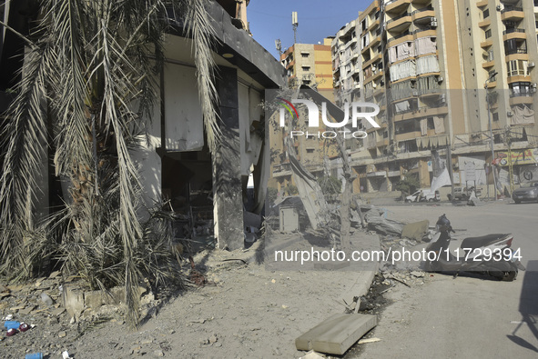 Firefighters extinguish the blaze at the site of overnight Israeli airstrikes that target the neighborhood of Kafaat in Beirut's southern su...