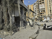 Firefighters extinguish the blaze at the site of overnight Israeli airstrikes that target the neighborhood of Kafaat in Beirut's southern su...