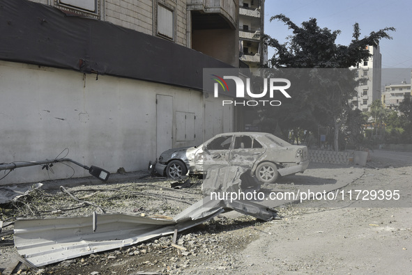 Firefighters extinguish the blaze at the site of overnight Israeli airstrikes that target the neighborhood of Kafaat in Beirut's southern su...