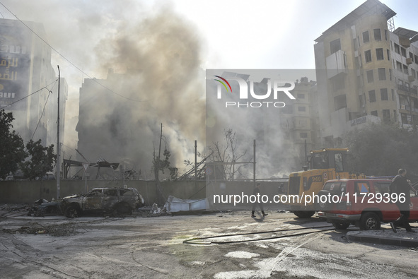 Firefighters extinguish the blaze at the site of overnight Israeli airstrikes that target the neighborhood of Kafaat in Beirut's southern su...