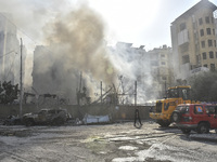 Firefighters extinguish the blaze at the site of overnight Israeli airstrikes that target the neighborhood of Kafaat in Beirut's southern su...