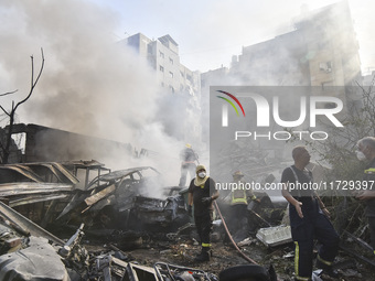 Firefighters extinguish the blaze at the site of overnight Israeli airstrikes that target the neighborhood of Kafaat in Beirut's southern su...