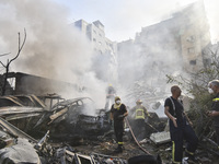 Firefighters extinguish the blaze at the site of overnight Israeli airstrikes that target the neighborhood of Kafaat in Beirut's southern su...