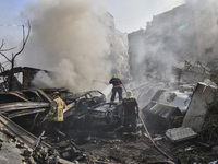 Firefighters extinguish the blaze at the site of overnight Israeli airstrikes that target the neighborhood of Kafaat in Beirut's southern su...