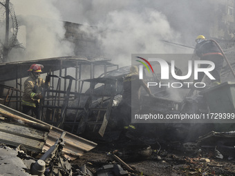 Firefighters extinguish the blaze at the site of overnight Israeli airstrikes that target the neighborhood of Kafaat in Beirut's southern su...