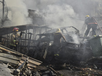 Firefighters extinguish the blaze at the site of overnight Israeli airstrikes that target the neighborhood of Kafaat in Beirut's southern su...