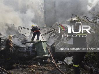 Firefighters extinguish the blaze at the site of overnight Israeli airstrikes that target the neighborhood of Kafaat in Beirut's southern su...