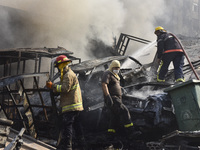 Firefighters extinguish the blaze at the site of overnight Israeli airstrikes that target the neighborhood of Kafaat in Beirut's southern su...