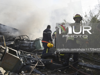 Firefighters extinguish the blaze at the site of overnight Israeli airstrikes that target the neighborhood of Kafaat in Beirut's southern su...