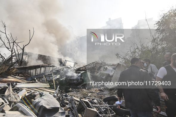 Firefighters extinguish the blaze at the site of overnight Israeli airstrikes that target the neighborhood of Kafaat in Beirut's southern su...