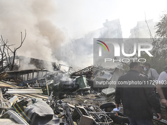 Firefighters extinguish the blaze at the site of overnight Israeli airstrikes that target the neighborhood of Kafaat in Beirut's southern su...