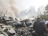 Firefighters extinguish the blaze at the site of overnight Israeli airstrikes that target the neighborhood of Kafaat in Beirut's southern su...