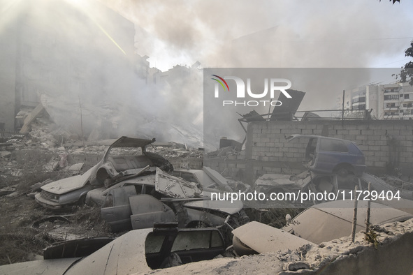 Firefighters extinguish the blaze at the site of overnight Israeli airstrikes that target the neighborhood of Kafaat in Beirut's southern su...