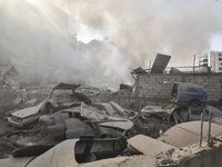 Firefighters extinguish the blaze at the site of overnight Israeli airstrikes that target the neighborhood of Kafaat in Beirut's southern su...