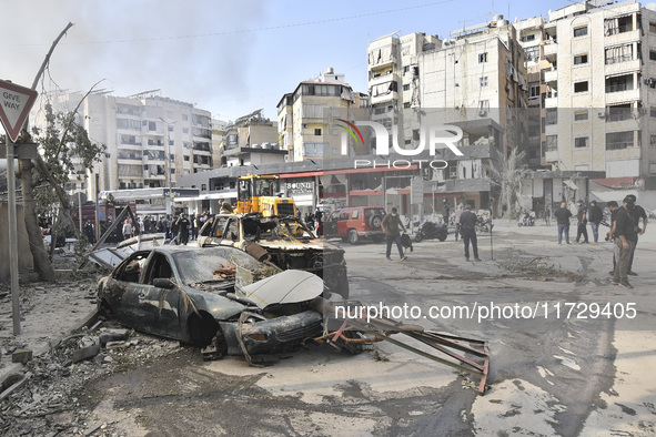 Firefighters extinguish the blaze at the site of overnight Israeli airstrikes that target the neighborhood of Kafaat in Beirut's southern su...