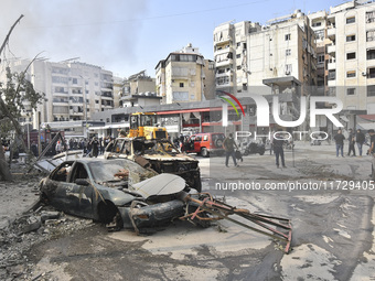 Firefighters extinguish the blaze at the site of overnight Israeli airstrikes that target the neighborhood of Kafaat in Beirut's southern su...