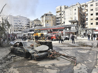 Firefighters extinguish the blaze at the site of overnight Israeli airstrikes that target the neighborhood of Kafaat in Beirut's southern su...