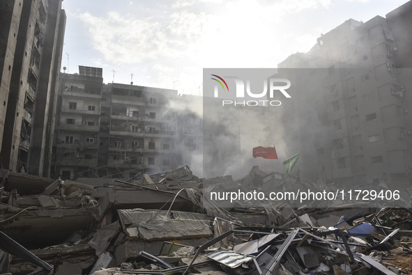 Firefighters extinguish the blaze at the site of overnight Israeli airstrikes that target the neighborhood of Kafaat in Beirut's southern su...