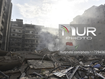 Firefighters extinguish the blaze at the site of overnight Israeli airstrikes that target the neighborhood of Kafaat in Beirut's southern su...