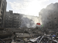 Firefighters extinguish the blaze at the site of overnight Israeli airstrikes that target the neighborhood of Kafaat in Beirut's southern su...