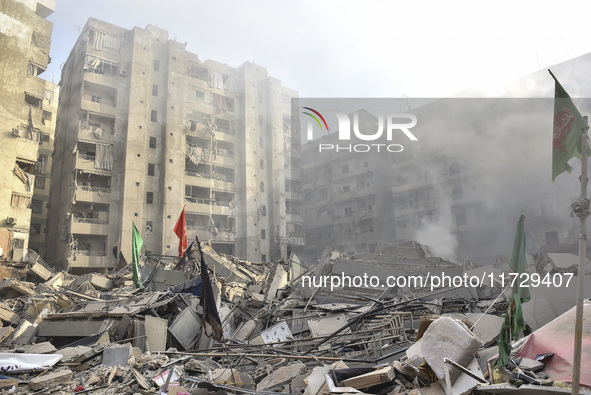 Firefighters extinguish the blaze at the site of overnight Israeli airstrikes that target the neighborhood of Kafaat in Beirut's southern su...