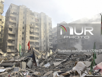 Firefighters extinguish the blaze at the site of overnight Israeli airstrikes that target the neighborhood of Kafaat in Beirut's southern su...