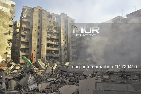 Firefighters extinguish the blaze at the site of overnight Israeli airstrikes that target the neighborhood of Kafaat in Beirut's southern su...