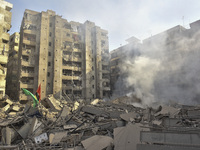 Firefighters extinguish the blaze at the site of overnight Israeli airstrikes that target the neighborhood of Kafaat in Beirut's southern su...