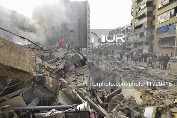 Firefighters extinguish the blaze at the site of overnight Israeli airstrikes that target the neighborhood of Kafaat in Beirut's southern su...