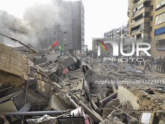 Firefighters extinguish the blaze at the site of overnight Israeli airstrikes that target the neighborhood of Kafaat in Beirut's southern su...