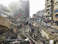 Firefighters extinguish the blaze at the site of overnight Israeli airstrikes that target the neighborhood of Kafaat in Beirut's southern su...