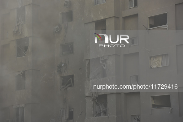 Firefighters extinguish the blaze at the site of overnight Israeli airstrikes that target the neighborhood of Kafaat in Beirut's southern su...