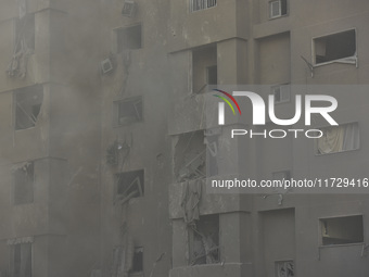 Firefighters extinguish the blaze at the site of overnight Israeli airstrikes that target the neighborhood of Kafaat in Beirut's southern su...